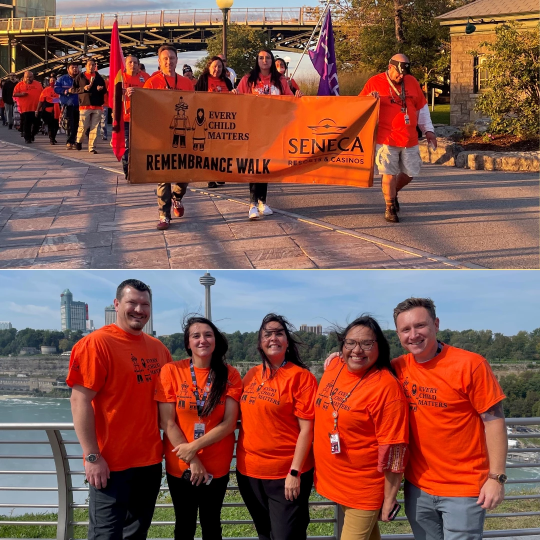 Team walking with orange shirts and banners.